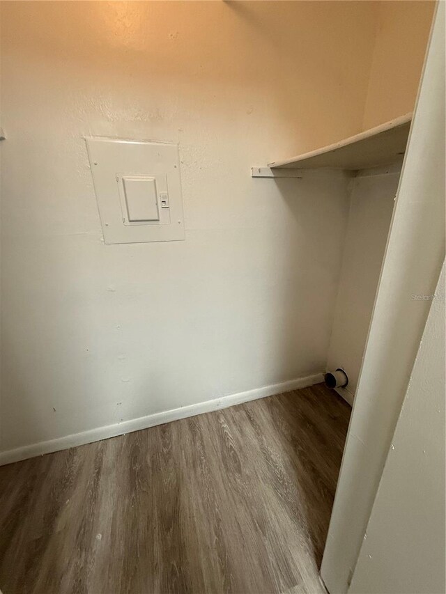 5540 Devonbriar Way Unit 103, Orlando, FL 32822 - laundry area featuring wood finished floors, baseboards, and electric panel