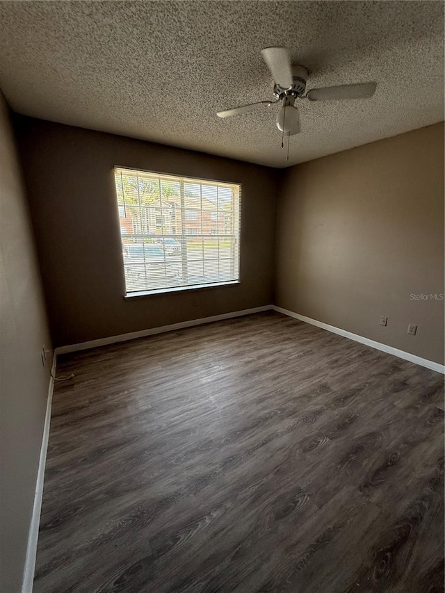 5540 Devonbriar Way Unit 103, Orlando, FL 32822 - spare room with a textured ceiling, ceiling fan, dark wood finished floors, and baseboards