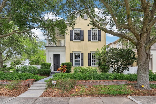 view of front of property with a balcony and stucco siding
