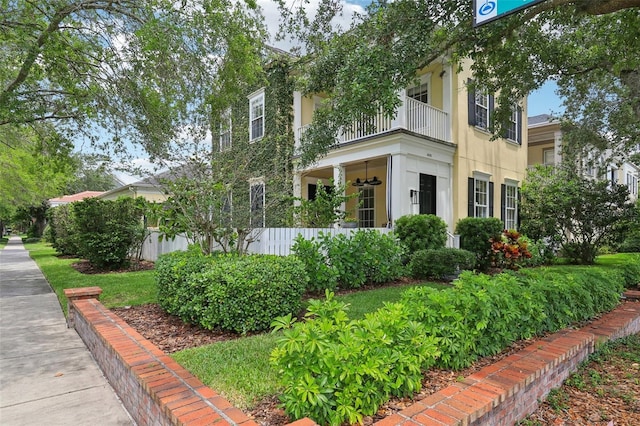 view of front of home with a balcony and stucco siding