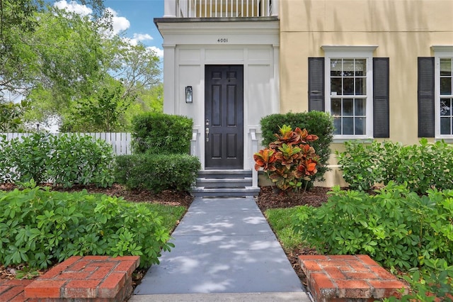 property entrance with stucco siding
