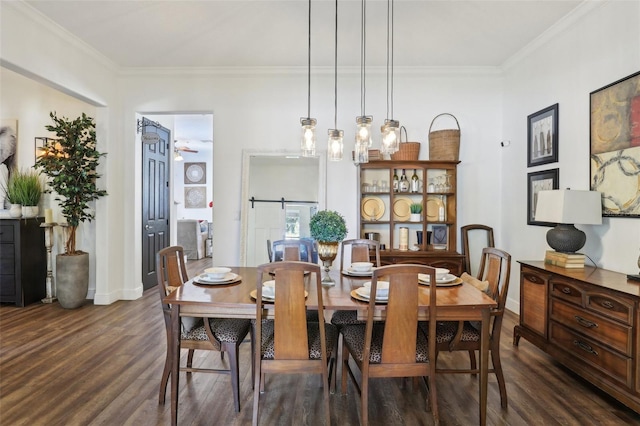 dining area featuring dark wood-style flooring, ornamental molding, and baseboards