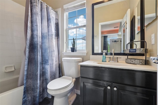 full bathroom featuring healthy amount of natural light, vanity, toilet, and shower / tub combo