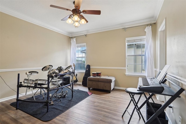 office featuring wood finished floors, ornamental molding, a ceiling fan, and baseboards