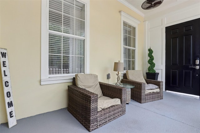 doorway to property with stucco siding, covered porch, and a ceiling fan