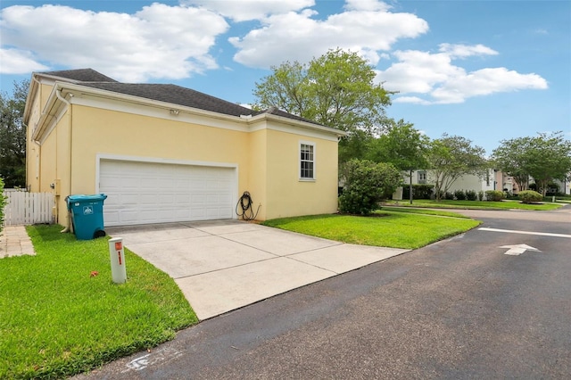 view of home's exterior featuring stucco siding, driveway, and a garage