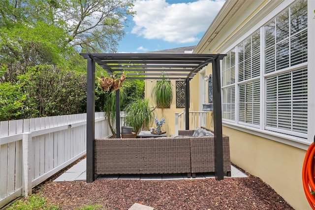 view of patio featuring fence, a pergola, and outdoor lounge area