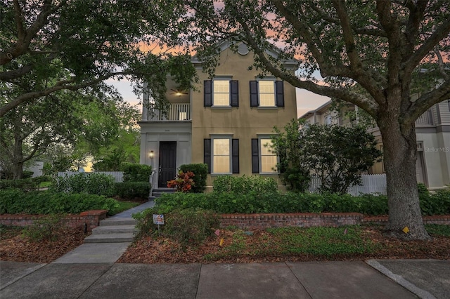 view of front of property with a balcony and stucco siding