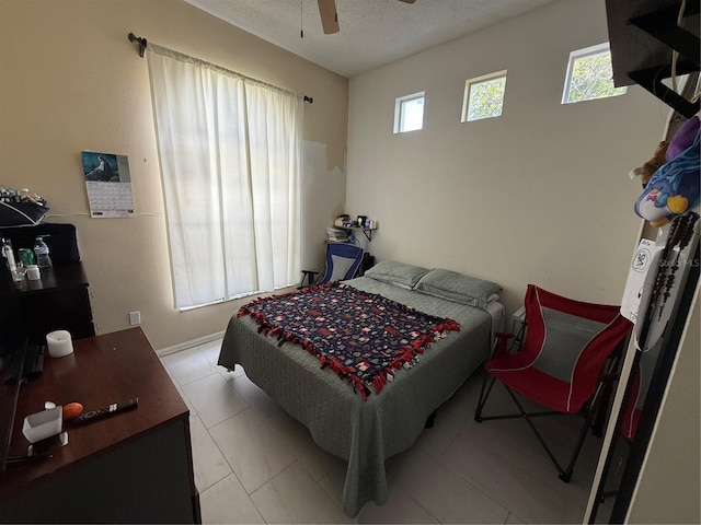 bedroom with a textured ceiling and ceiling fan