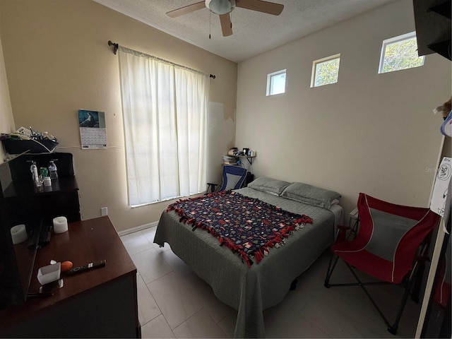bedroom with a textured ceiling and ceiling fan