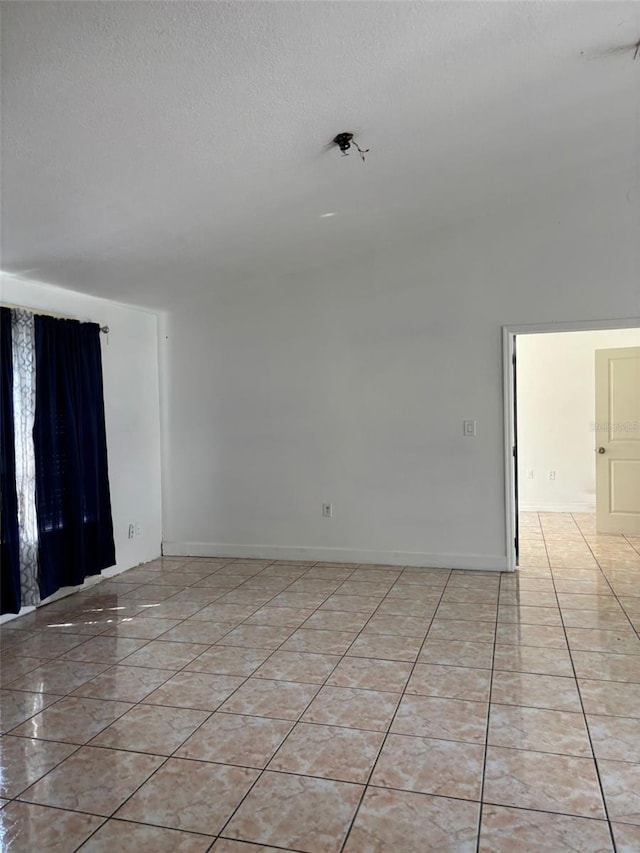 233 Red Maple Dr, Kissimmee, FL 34743 - spare room featuring a textured ceiling and baseboards