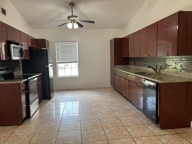 233 Red Maple Dr, Kissimmee, FL 34743 - kitchen featuring range with electric stovetop, stainless steel microwave, dishwasher, a sink, and tasteful backsplash