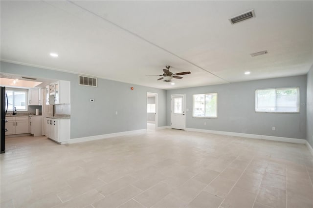4651 Helena St NE, Saint Petersburg, FL 33703 - unfurnished living room with ceiling fan, recessed lighting, baseboards, and a sink