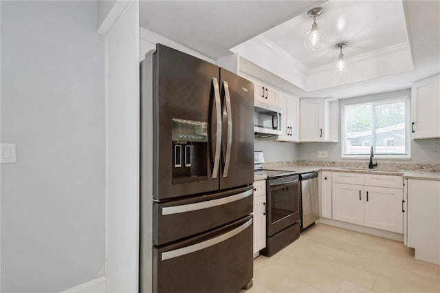 4651 Helena St NE, Saint Petersburg, FL 33703 - kitchen with appliances with stainless steel finishes, a sink, white cabinets, crown molding, and a tray ceiling