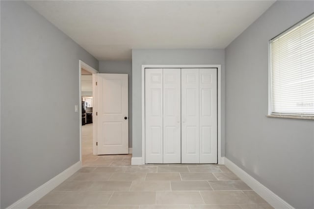 4651 Helena St NE, Saint Petersburg, FL 33703 - unfurnished bedroom with baseboards and a closet