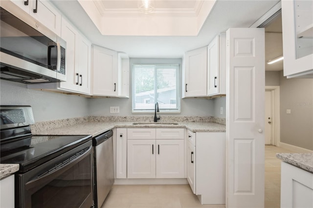 4651 Helena St NE, Saint Petersburg, FL 33703 - kitchen featuring appliances with stainless steel finishes, a sink, white cabinets, light stone counters, and light tile patterned flooring