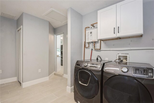 4651 Helena St NE, Saint Petersburg, FL 33703 - laundry area featuring attic access, washing machine and clothes dryer, cabinet space, water heater, and baseboards
