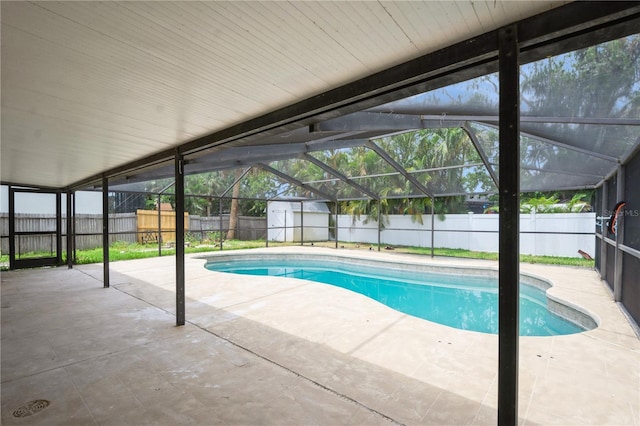4651 Helena St NE, Saint Petersburg, FL 33703 - view of swimming pool featuring a patio, a fenced backyard, a shed, an outdoor structure, and a lanai
