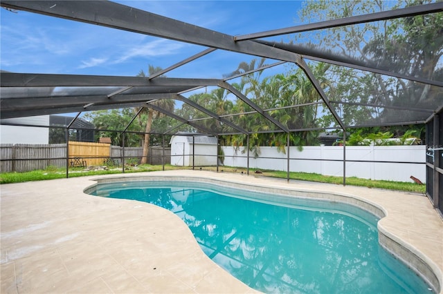 4651 Helena St NE, Saint Petersburg, FL 33703 - view of swimming pool featuring a fenced backyard, a patio area, glass enclosure, a shed, and an outdoor structure