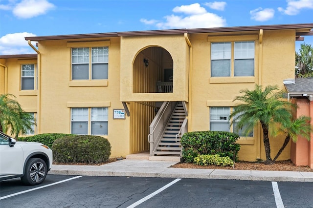 758 E Michigan St Unit 208, Orlando, FL 32806 - view of building exterior with uncovered parking and stairway