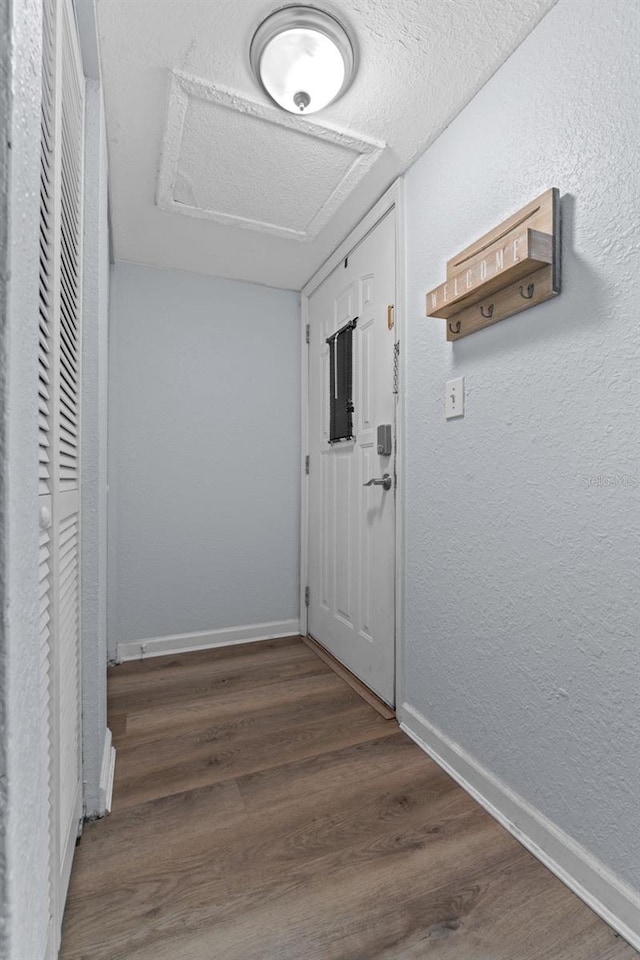 758 E Michigan St Unit 208, Orlando, FL 32806 - hall featuring attic access, wood finished floors, baseboards, and a textured wall