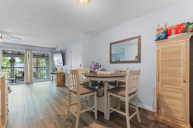 758 E Michigan St Unit 208, Orlando, FL 32806 - dining area with wood finished floors, baseboards, a textured ceiling, and ceiling fan