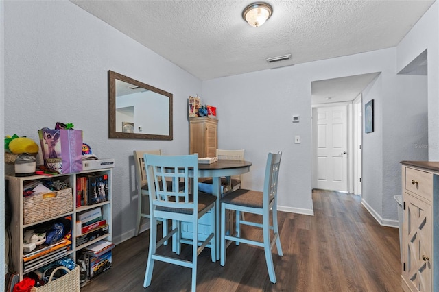 758 E Michigan St Unit 208, Orlando, FL 32806 - dining room with dark wood-style floors, a textured ceiling, and baseboards