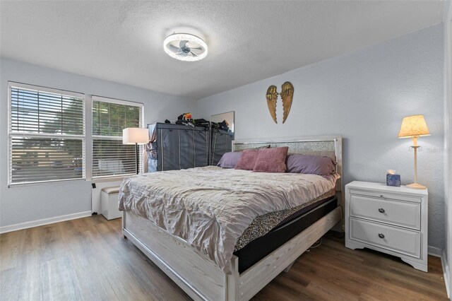758 E Michigan St Unit 208, Orlando, FL 32806 - bedroom with dark wood-style flooring, baseboards, and a textured ceiling