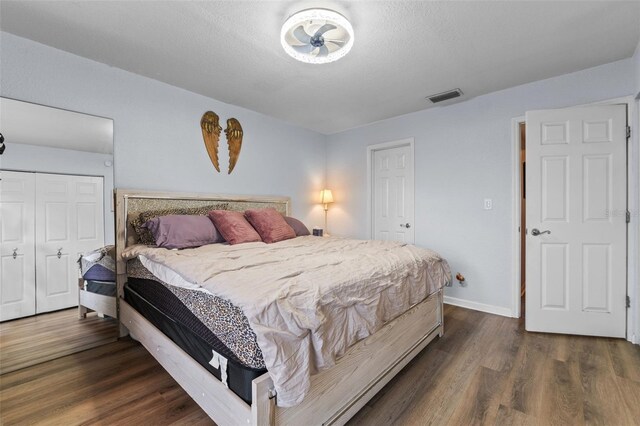 758 E Michigan St Unit 208, Orlando, FL 32806 - bedroom with dark wood-type flooring, a closet, and baseboards