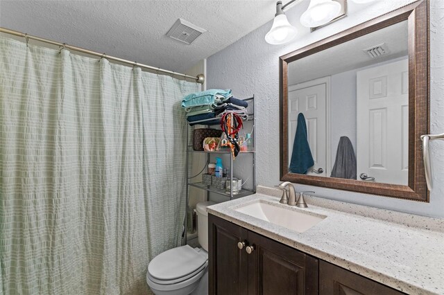 758 E Michigan St Unit 208, Orlando, FL 32806 - full bathroom with a textured wall, vanity, toilet, a textured ceiling, and curtained shower