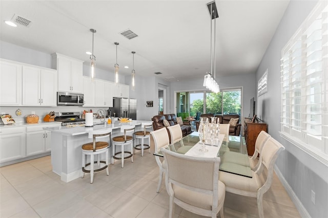 dining area featuring recessed lighting and light tile patterned floors