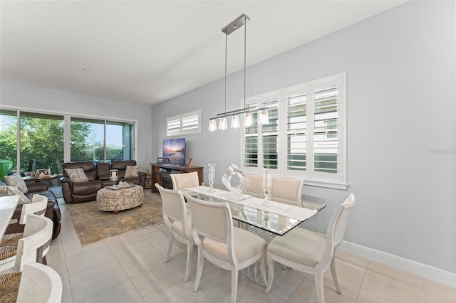 dining space with light tile patterned floors and baseboards