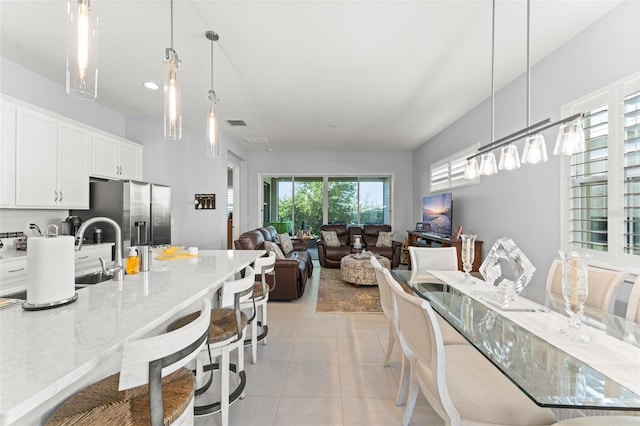 dining space featuring light tile patterned flooring