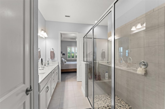 bathroom featuring tile patterned flooring, ensuite bathroom, vanity, and a stall shower