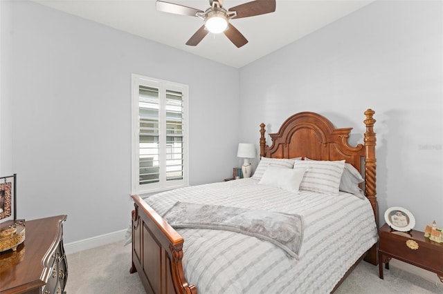 bedroom with light carpet, baseboards, and ceiling fan