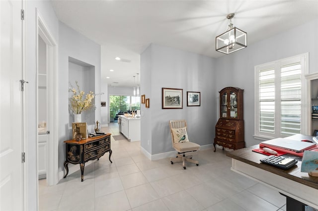 sitting room with a chandelier, baseboards, light tile patterned floors, and recessed lighting