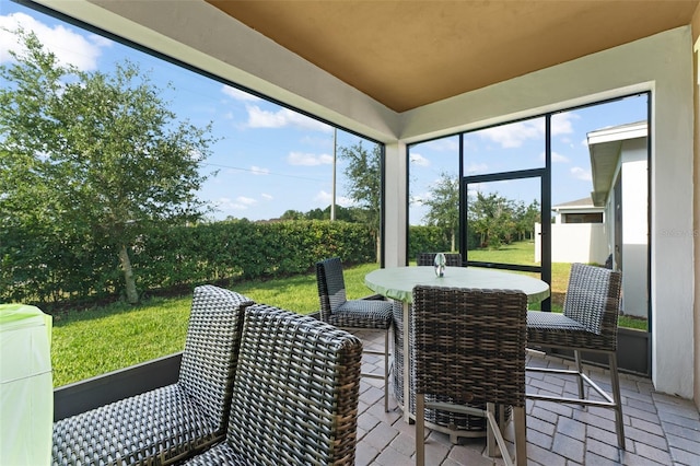 sunroom / solarium featuring outdoor dining area
