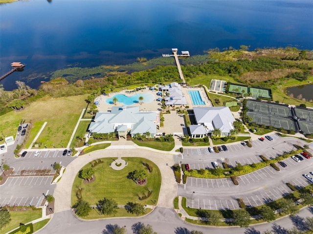aerial overview of property's location featuring a pool and a nearby body of water