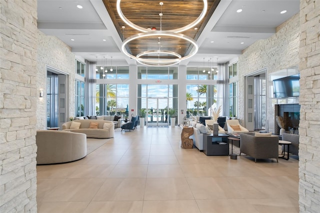 lobby featuring a high ceiling, beam ceiling, and recessed lighting