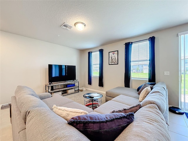 1045 Desert Candle Dr, Ocoee, FL 34761 - living room featuring tile patterned flooring, baseboards, and a textured ceiling