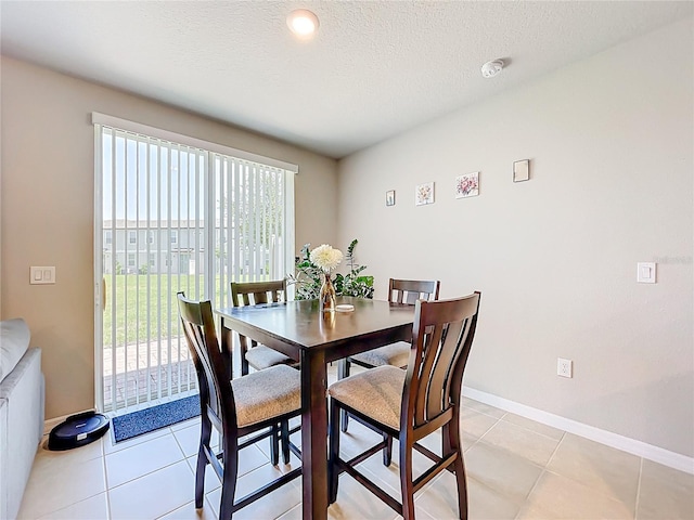 1045 Desert Candle Dr, Ocoee, FL 34761 - dining room with baseboards, light tile patterned flooring, and a textured ceiling