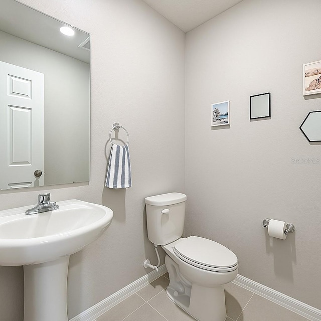1045 Desert Candle Dr, Ocoee, FL 34761 - bathroom featuring baseboards, toilet, tile patterned flooring, and a sink