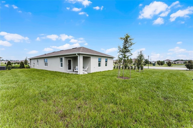 3434 Briarwood Grove Dr, Ocoee, FL 34761 - rear view of house with stucco siding, a yard, and central AC unit