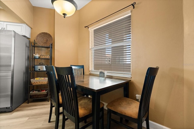 dining area featuring light wood-style flooring