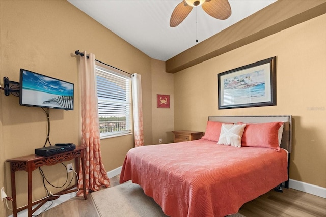 bedroom featuring wood finished floors, baseboards, and ceiling fan