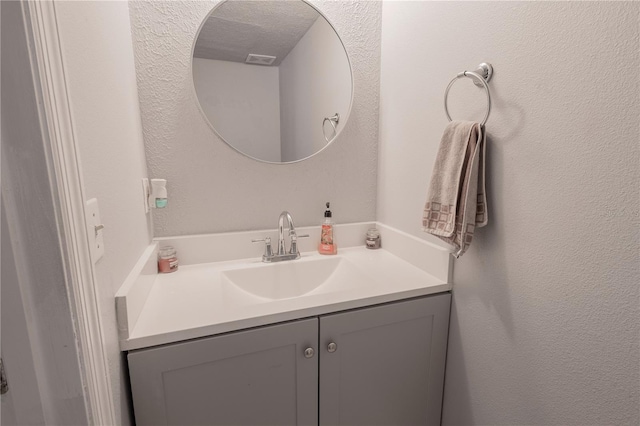 3216 White Blossom Ln, Clermont, FL 34711 - bathroom with vanity and a textured wall