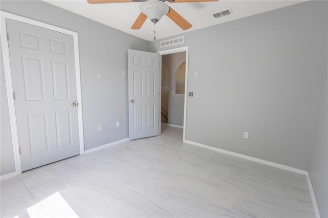3216 White Blossom Ln, Clermont, FL 34711 - unfurnished bedroom with arched walkways and a ceiling fan