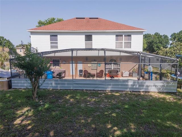 3216 White Blossom Ln, Clermont, FL 34711 - rear view of house featuring a lawn, a patio, and a shingled roof