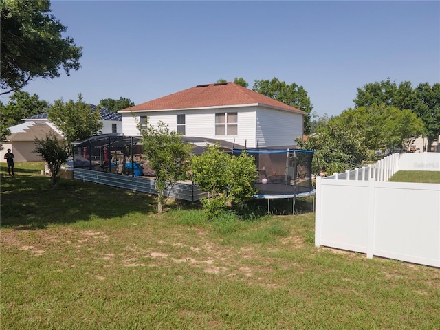 3216 White Blossom Ln, Clermont, FL 34711 - rear view of property featuring a trampoline