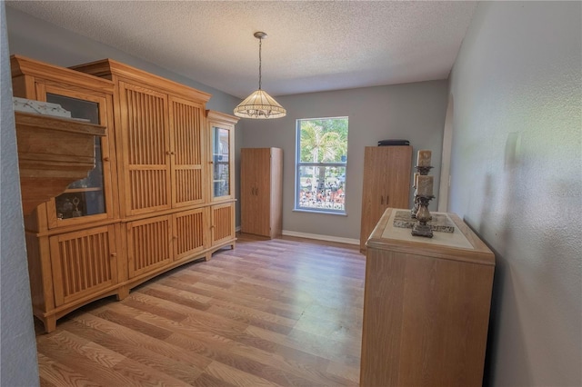 3216 White Blossom Ln, Clermont, FL 34711 - unfurnished dining area featuring wood finished floors and a textured ceiling